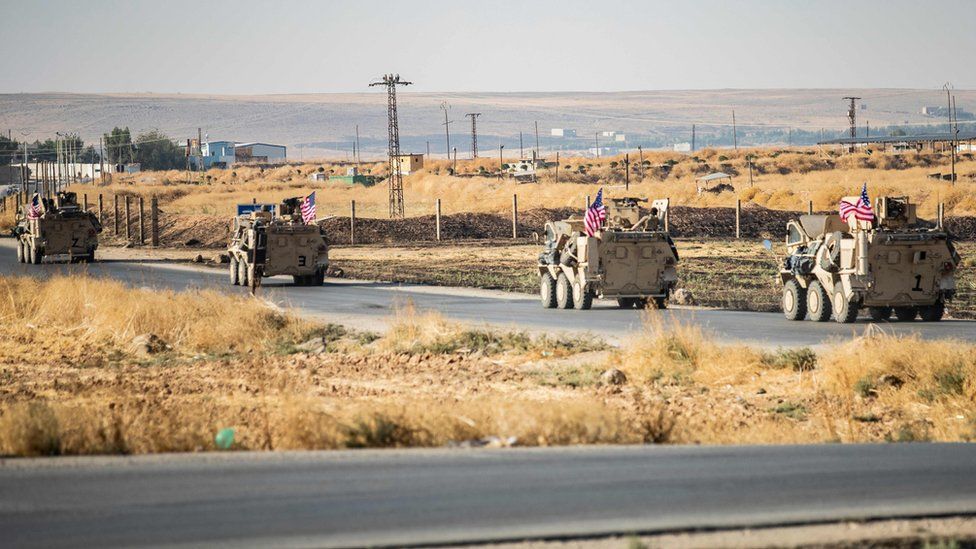 US military vehicles patrol near the Syrian town of Tal Baydar on 12 October 2019