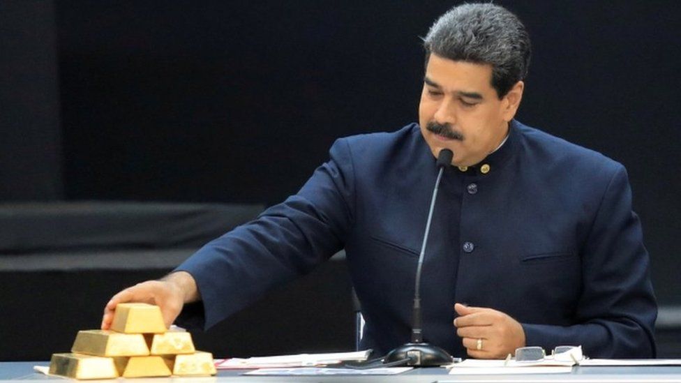 Venezuela"s President Nicolas Maduro touches a gold bar as he speaks during a meeting with the ministers responsible for the economic sector at Miraflores Palace in Caracas, Venezuela March 22, 2018.