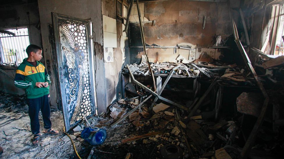 Palestinian inspects the damage inside a destroyed house in the Jenin refugee camp after it was targeted by the Israeli army on 13 December