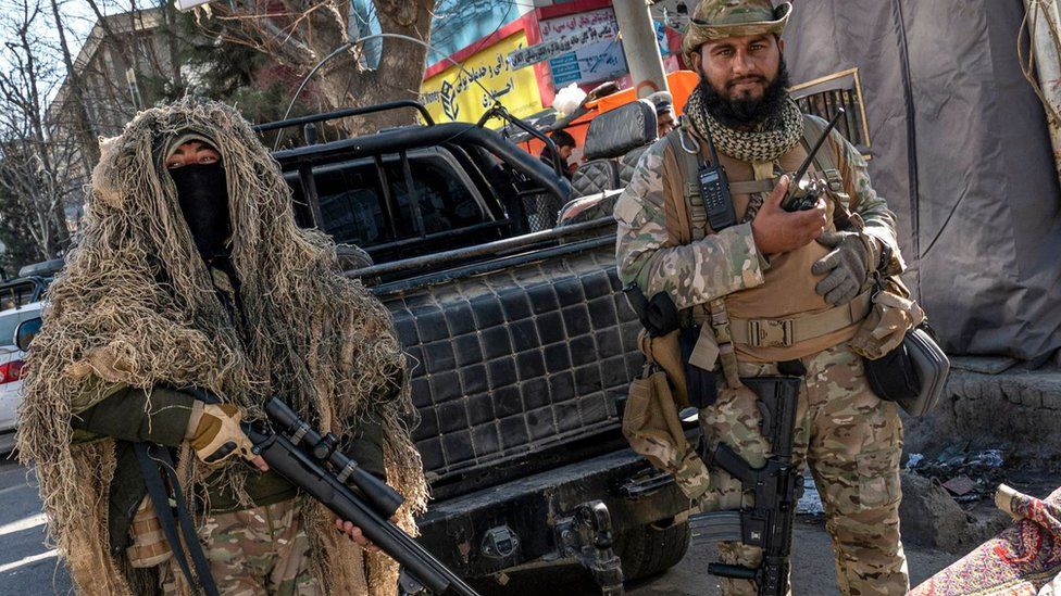 Taliban militants with snipper rifles and assault rifles are stopping women from entering university