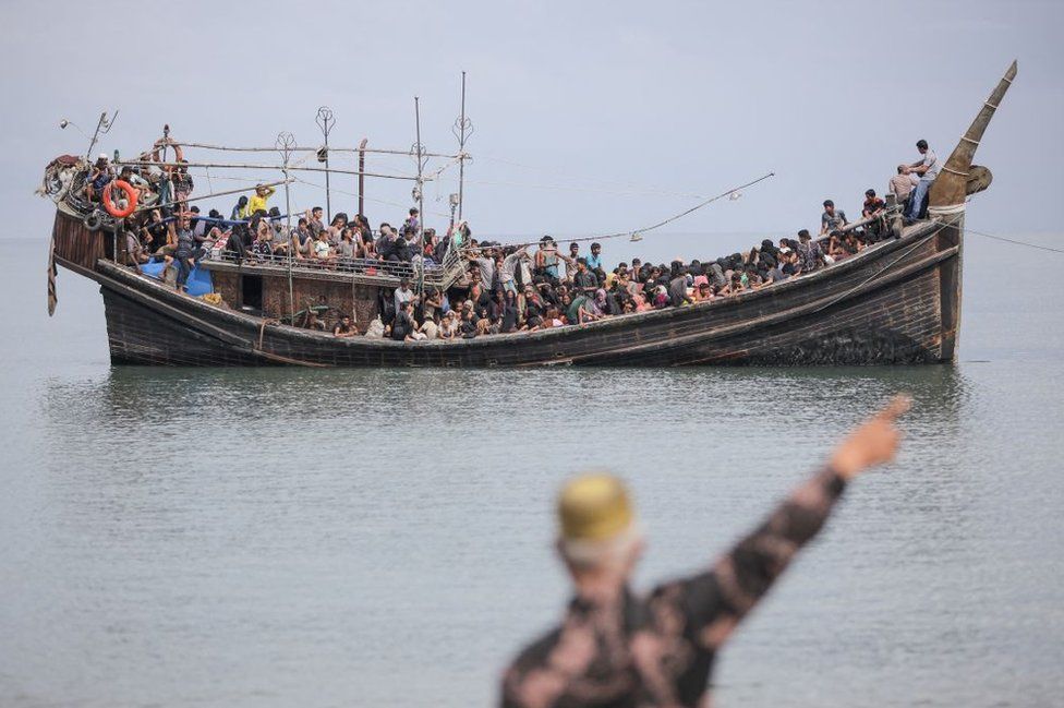 Newly arrived Rohingya refugees are stranded on a boat after the nearby community decided not to allow them to land after giving them water and food in Pineung, Aceh province on November 16, 2023.