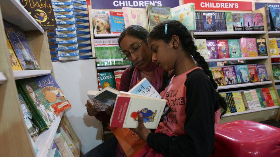 Woman and child in book shop