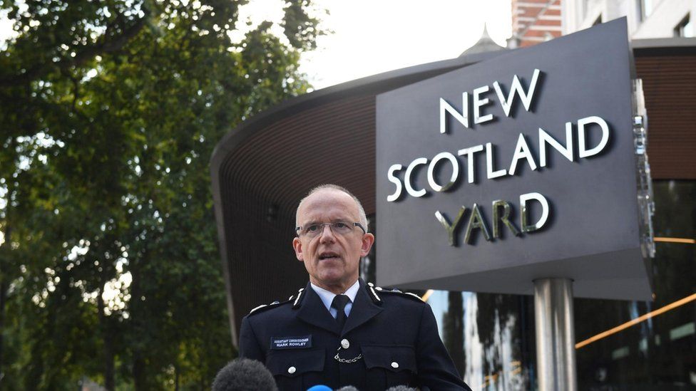 Met Police commissioner Sir Mark Rowley stands in front of the New Scotland Yard sign