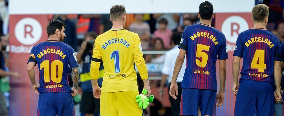 Barcelona's Argentinian forward Lionel Messi, German goalkeeper Marc-Andre Ter Stegen and teammates stand with their jerseys reading "Barcelona"