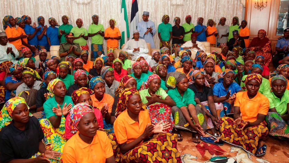 Nigeria's President Muhammadu Buhari, pictured sitting among the 82 rescued Chibok girls during a reception ceremony at the Presidential Villa in Abuja, on 7 May, 2017