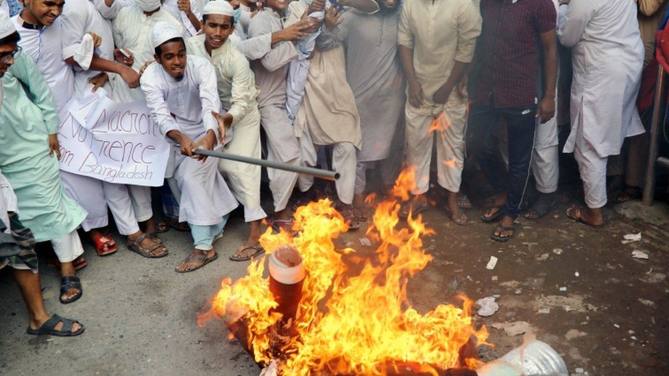 Supporters and activists of the Islami Oikya Jote, an Islamist political party, burn an effigy of French president Emmanuel Macron