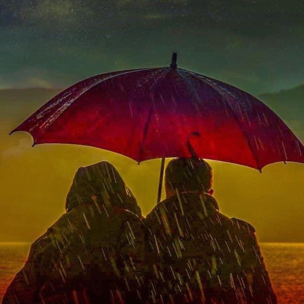Couple under umbrella in rain