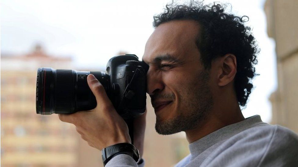Egyptian award-winning photographer Mahmoud Abu Zeid, also known as Shawkan, takes pictures after his release, at his home in Cairo, Egypt, on 4 March 2019.