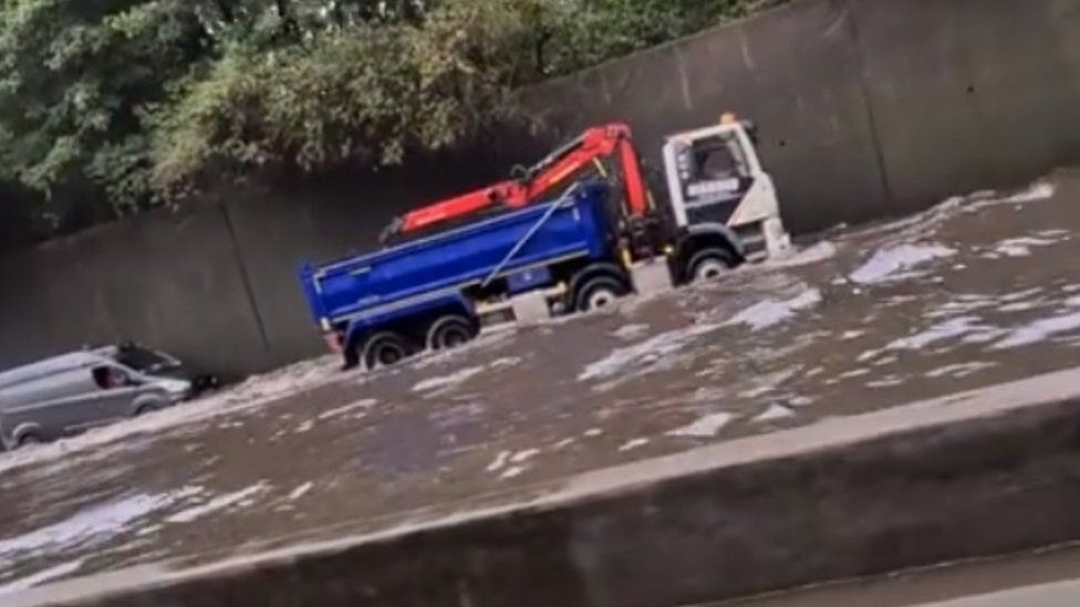 Screen grab from footage taken with permission from the Facebook page of Matt Hickmott of flash flooding on the M25, where it was also raining and hailing. PA Photo. Issue date: Thursday August 13, 2020.