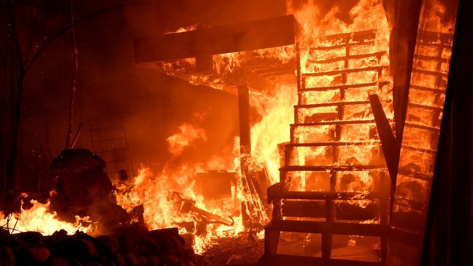 A home is engulfed in flames during the Woolsey Fire in Malibu