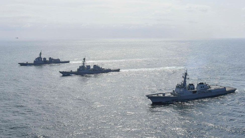 South Korean Navy's destroyer Yulgok Yi I (R), U.S. Navy's USS Benfold (C) and Japan Maritime Self-Defense Force's JS Atago (L) sail in formation during a joint naval exercise in international waters on April 17, 2023