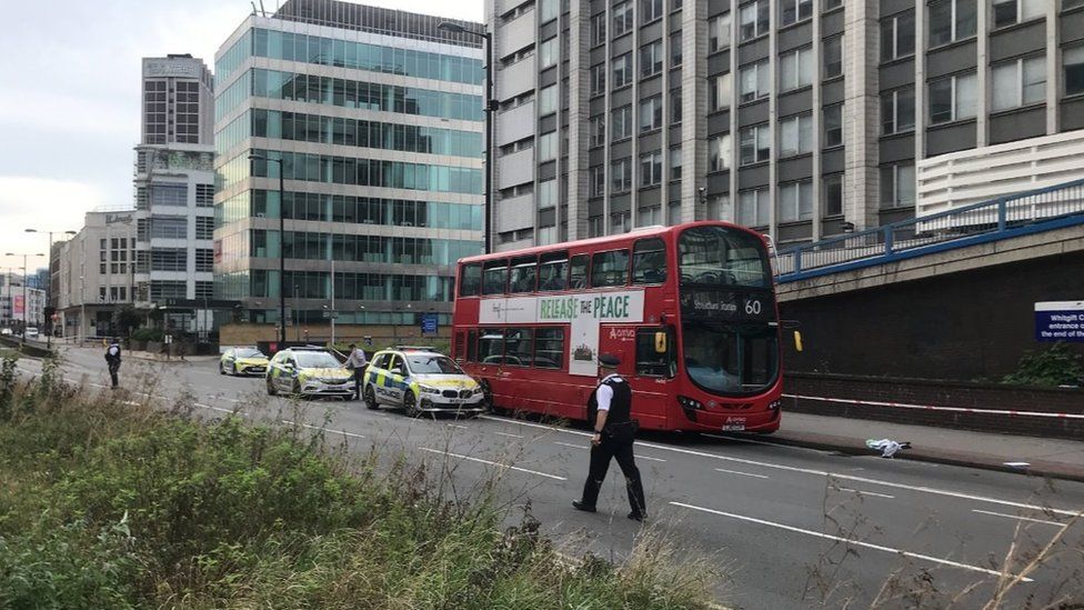 Image showing three police cars and officers near a number 60 double decker bus on Wellesley Road in Croydon