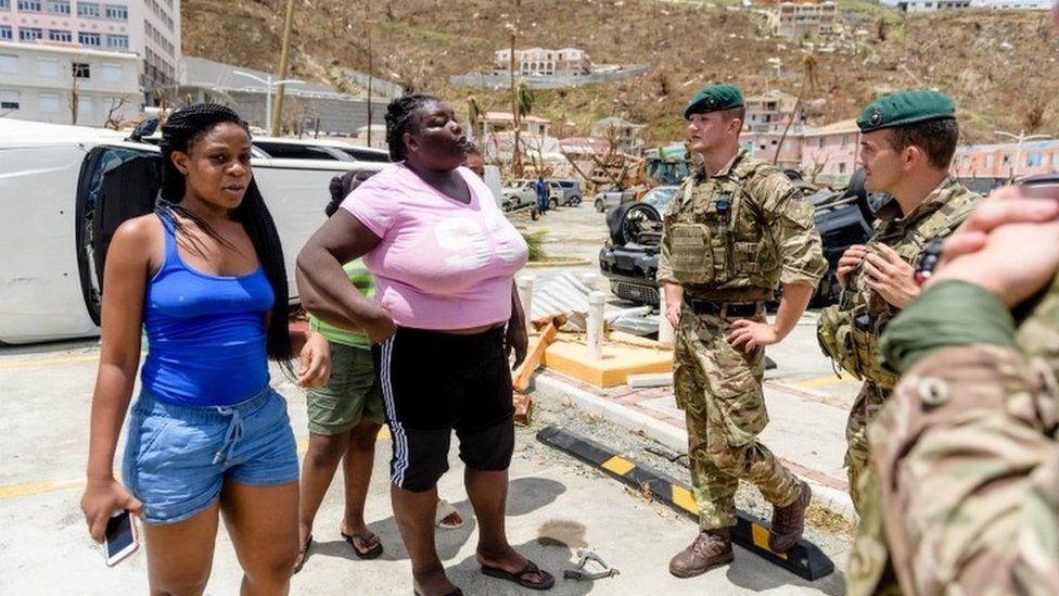 Royal Marines of 40 Commando speak to the locals in the British Virgin Isles