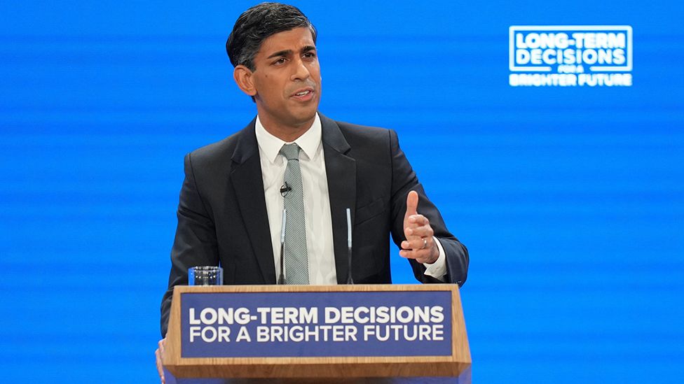 Rishi Sunak speaking on stage at Conservative conference 4 October