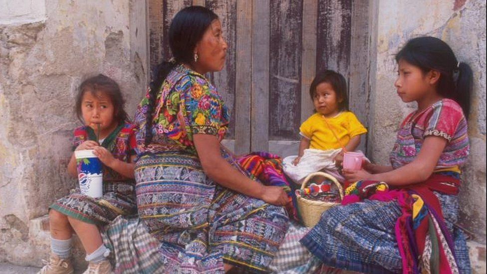 A family of women wearing brightly coloured clothes