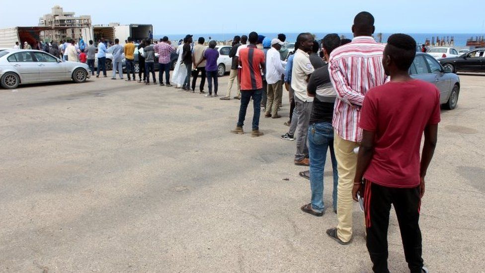 Migrants queue for food aid. Libya is a major transit point for attempts to reach Europe. File image