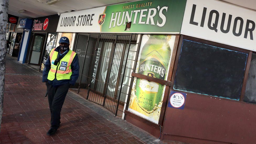 Police officer outside a liquor store in Cape Town
