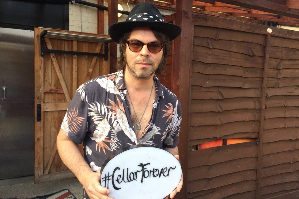 Gaz Coombes with #CellarForever sign