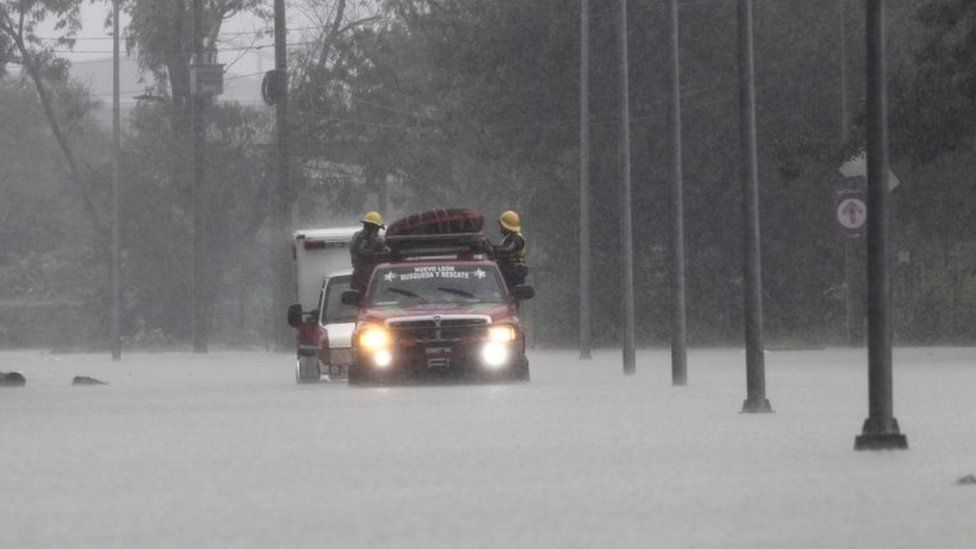 Fire service vehicle tows an ambulance on a flooded street during Storm Hanna in Apodaca on the outskirts of Monterrey, Mexico July 26, 2020