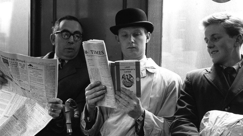 Fox photographer George Freston poses as a commuter on the London Underground, reading a copy of D H Lawrence's novel 'Lady Chatterley's Lover',