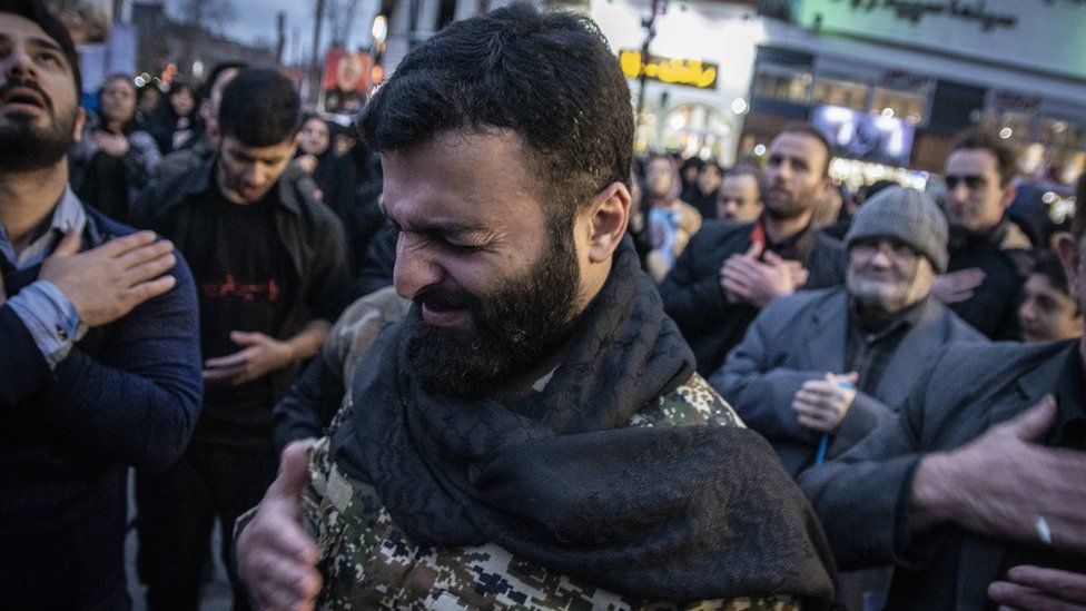 Man crying at funeral of General Qasem Soleimani