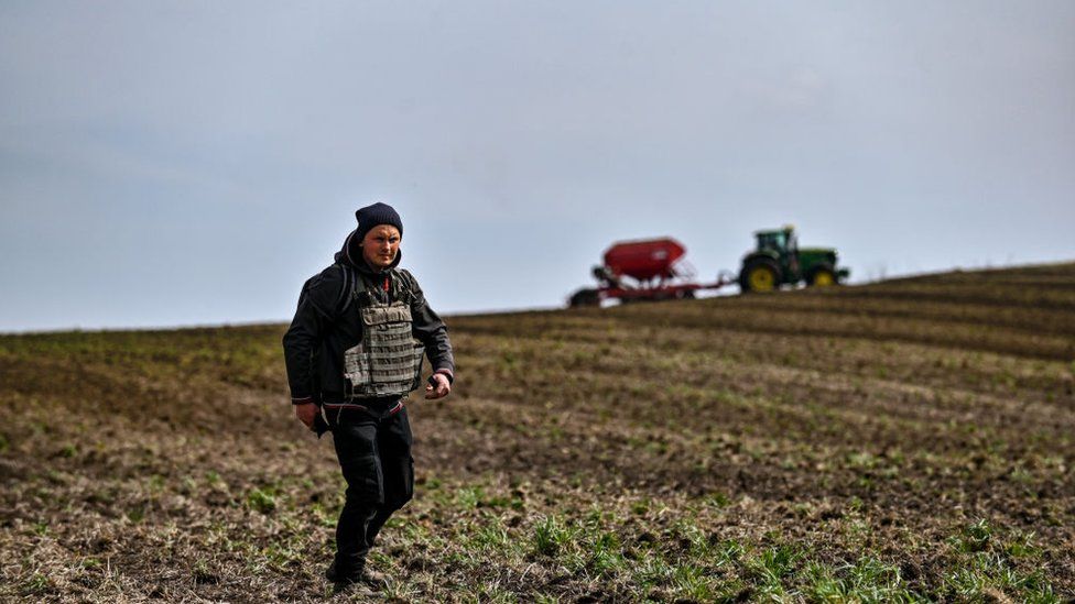 A farmer wears a flak jacket during the spring sowing in Zaporizhzhia region, south-eastern Ukraine