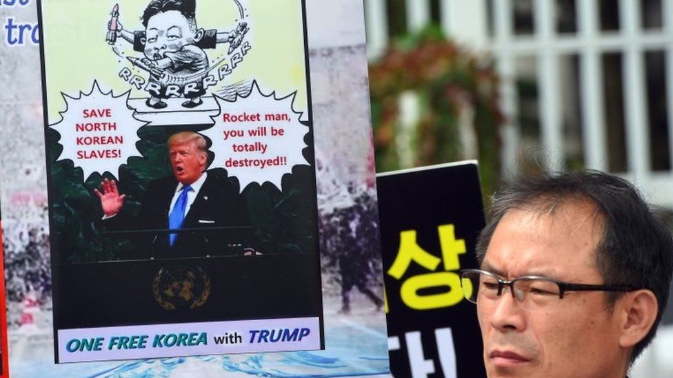 A South Korean protestor holds a placard showing a picture of US President Donald Trump during an anti-North Korea rally outside South Korean government complex in Seoul on 22 September 2017.