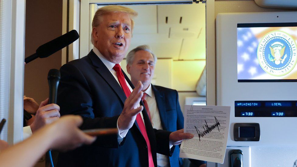 US President Donald Trump speaks to reporters on board Air Force One while returning to Washington from Cape Canaveral, Florida, US, 30 May 2020