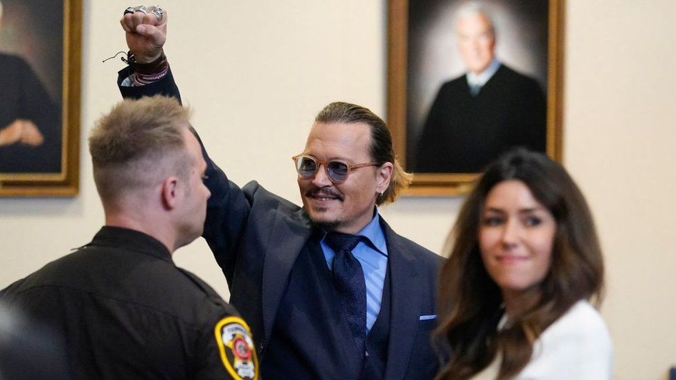 Johnny Depp stands with his lawyer in court