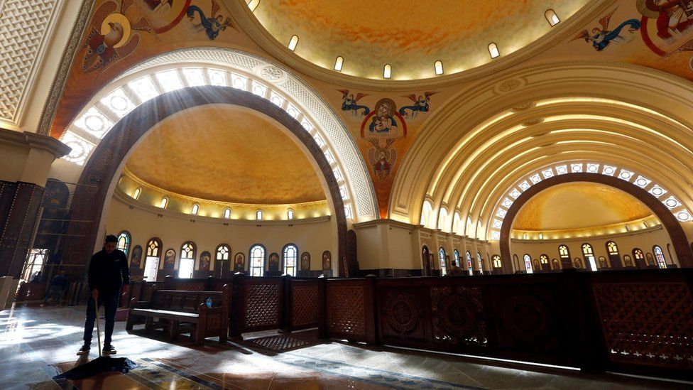 A worker cleans the interior of the new Coptic Cathedral of the Nativity at the New Administrative Capital