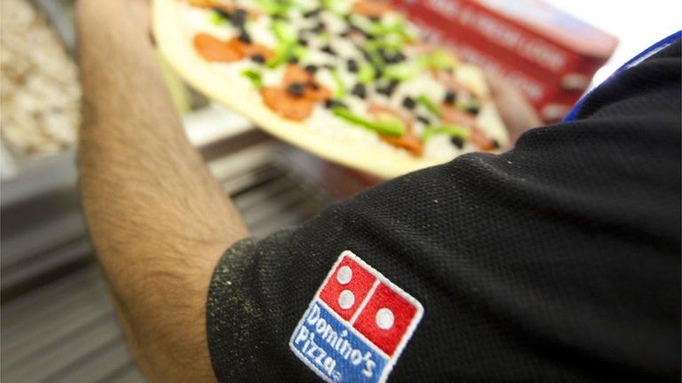 Domino's Pizza being made
