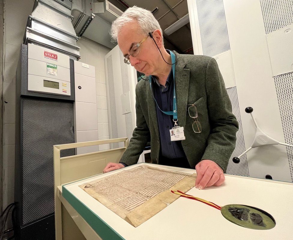 City archivist Martin Taylor examines Hull's royal charter of 1299