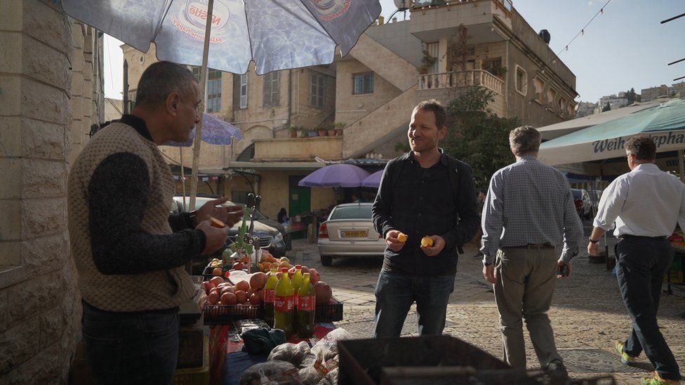 Maoz talks to a Nazareth stallholder