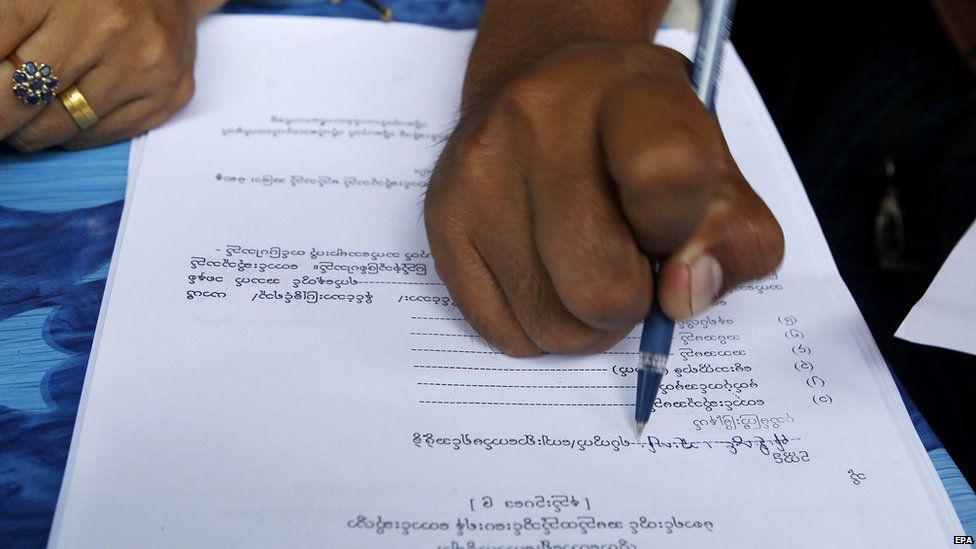 A person fills out their voter registration form in preparation for upcoming general elections, in Mandalay, Myanmar, 08 July 2015