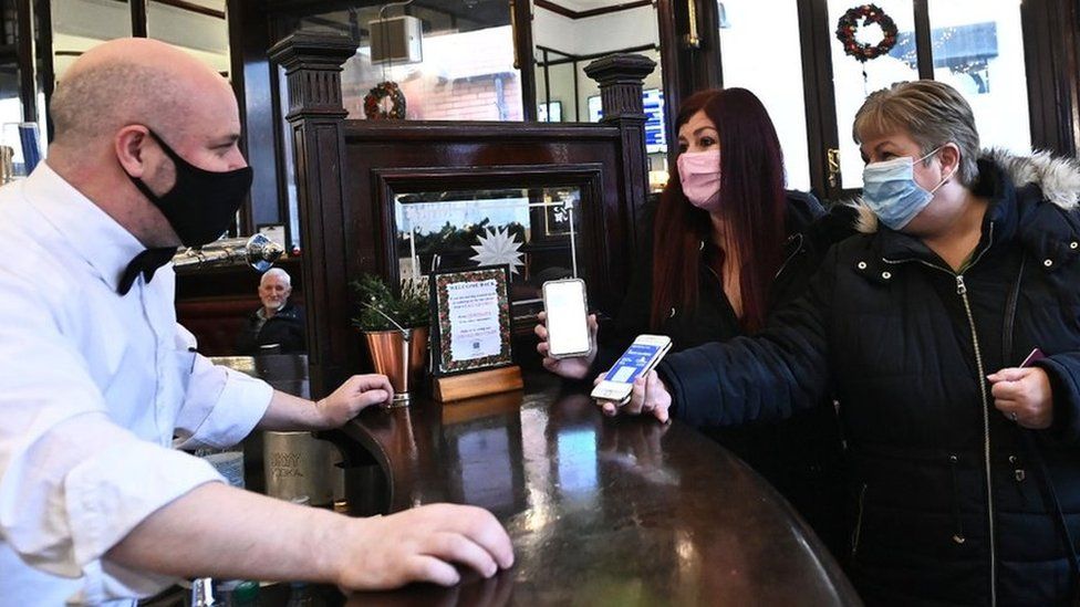 Customers showing Covid passports in Belfast pub