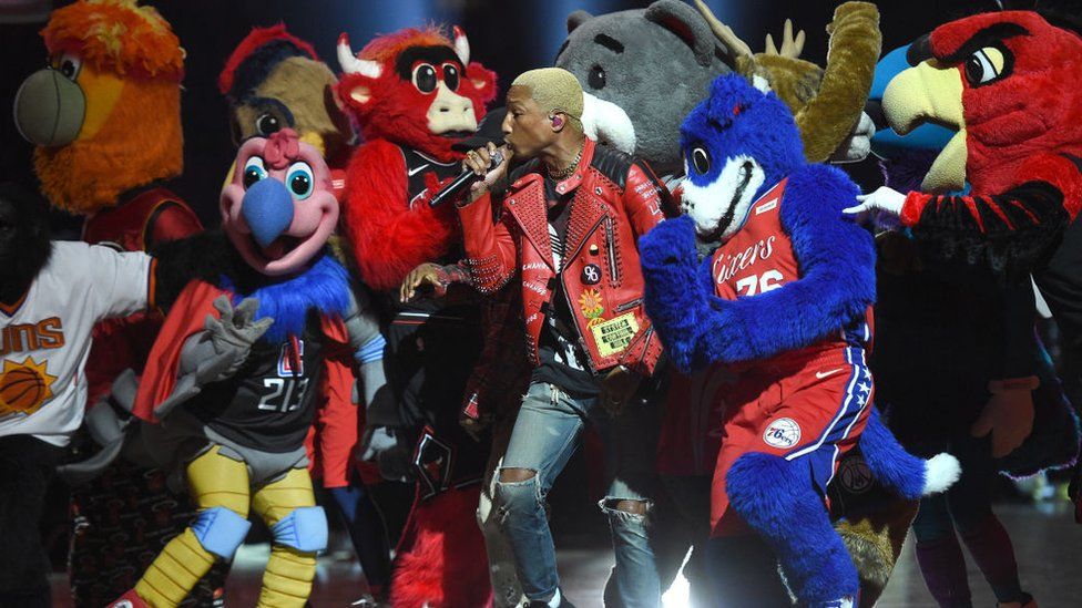 Pharrell performing with mascots