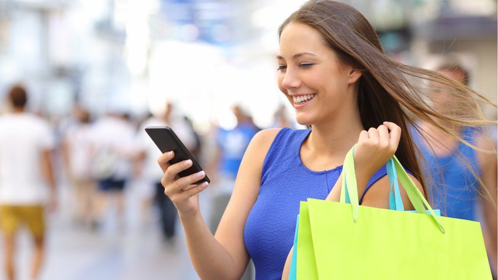 Young woman shopping with mobile phone