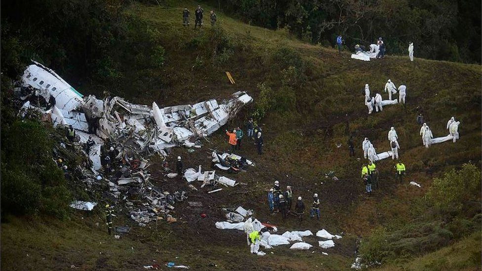 This file photo taken on November 29, 2016 shows rescuers searching for survivors from the wreckage of the LAMIA airlines charter plane carrying members of the Chapecoense Real football team that crashed in the mountains of Cerro Gordo, municipality of La Union, on November 29, 2016.