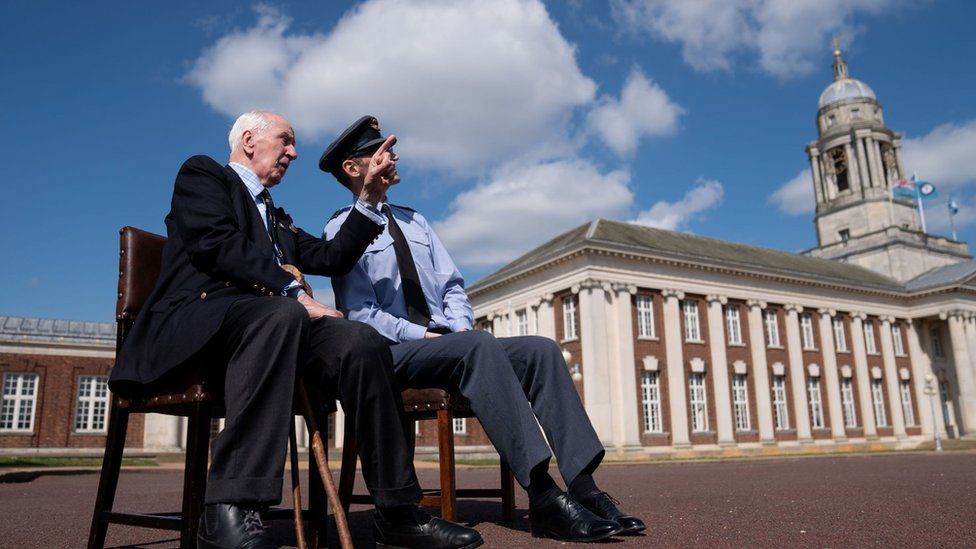 Former RAF Squadron Leader Terrance Devey Smith and Wing Commander Richard Podmore watching the rehearsal on a bench