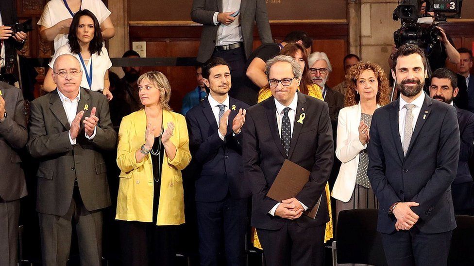 Catalan regional Government President, Quim Torra (front, R), and Catalan Parliament Speaker, Roger Torrent (front, L) are applauded by the new ministers of the Catalan Governmet, at the swearing-in ceremony at the Palau de la Generalitat in Barcelona, northeastern Spain on 2 June 2018.