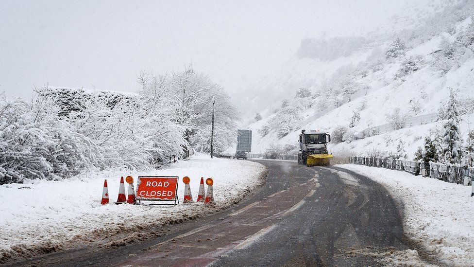 A snowplough clears a closed road on the A470 from Merthyr Tydfil to Brecon, Wales