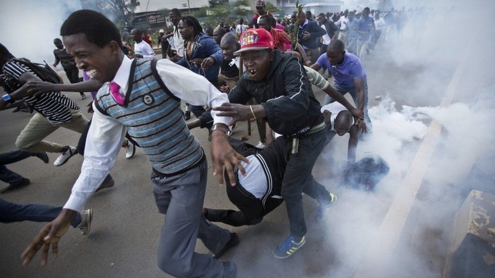 Opposition supporters flee from tear gas grenades fired by riot police, during a protest in downtown Nairobi, Kenya Monday, May 16, 201