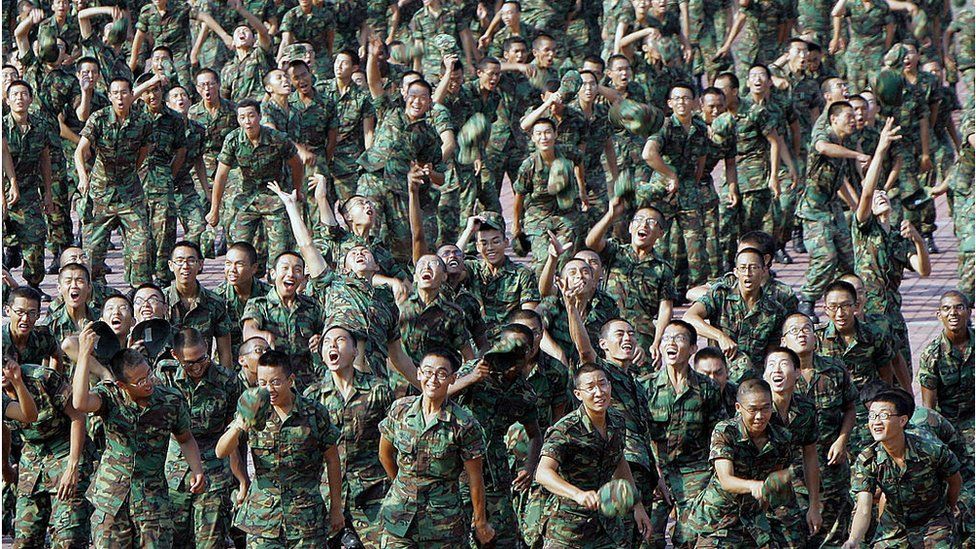 Recruits throw their cap in the air at the passing-out-parade