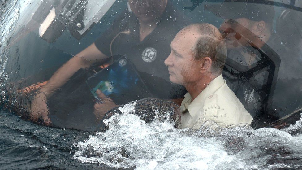 Vladimir Putin drives a submarine