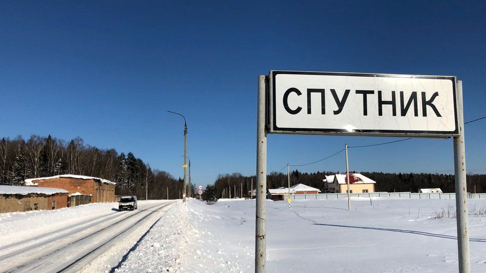 A sign in Russian at the entrance to Sputnik village