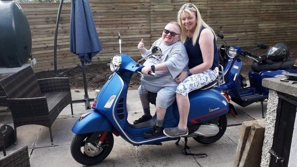 Caroline Wheeler and Lee Martin on a scooter