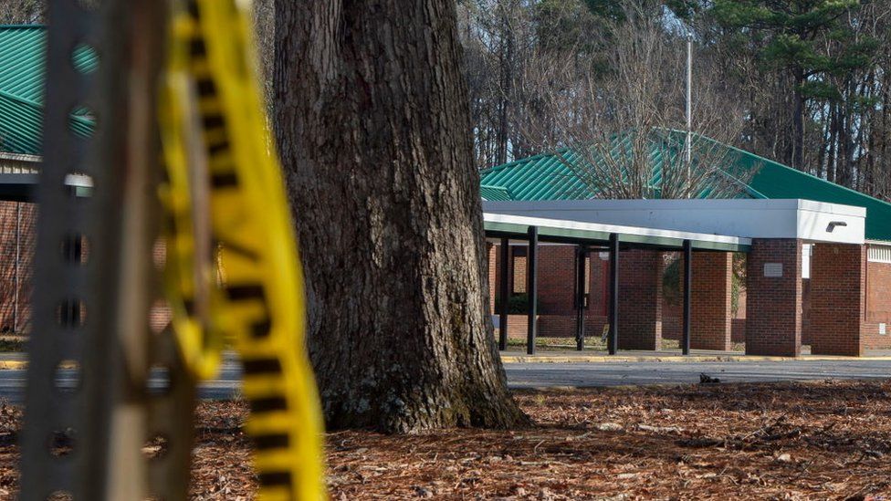 Police tape hangs from a sign post outside Richneck Elementary School following a shooting on January 7, 2023 in Newport News, Virginia