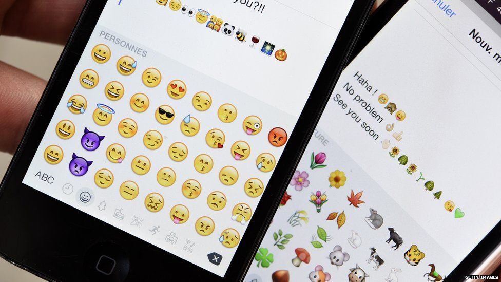 Phone screens with emojis on them