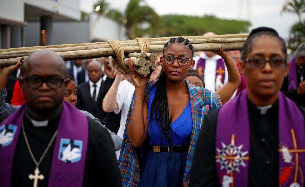 Christian faithful carrying a cross during a silent march in Durban, South Africa. April 14, 2017. REUTERS/Rogan Ward