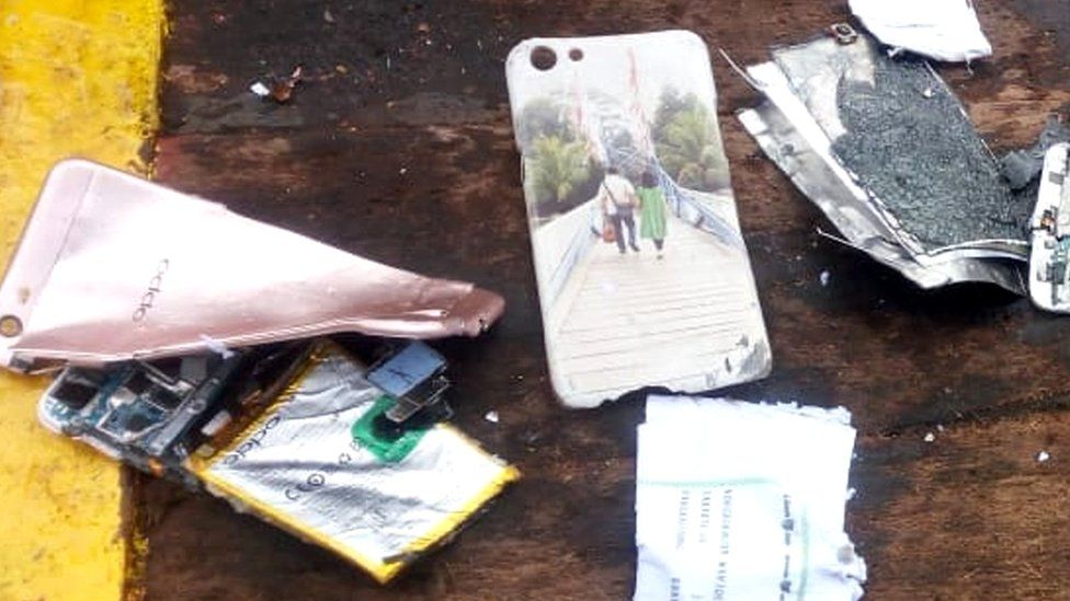 Damaged phone and phone case showing a couple walking across a bridge